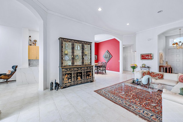 living room with light tile flooring, ornamental molding, and a notable chandelier