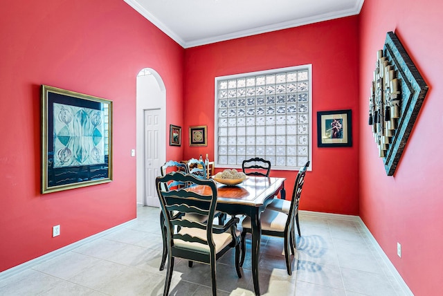 dining space with ornamental molding and light tile flooring