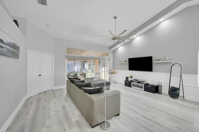 living room with high vaulted ceiling, ceiling fan, light hardwood / wood-style floors, and beamed ceiling