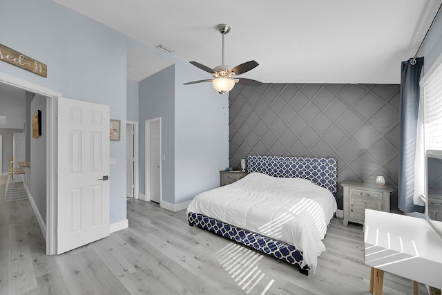 bedroom featuring light hardwood / wood-style floors, high vaulted ceiling, and ceiling fan