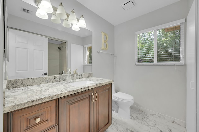 bathroom featuring tile flooring, vanity, and toilet