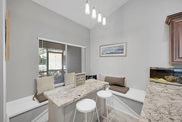 dining space with high vaulted ceiling