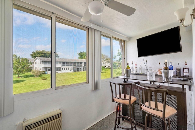 interior space with ceiling fan