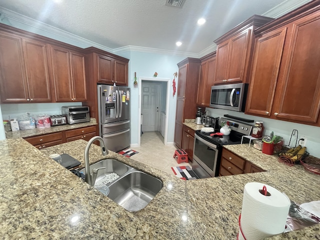 kitchen with light stone countertops, sink, stainless steel appliances, light tile patterned floors, and ornamental molding