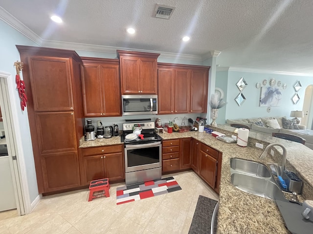 kitchen featuring ornamental molding, a textured ceiling, stainless steel appliances, sink, and light tile patterned floors