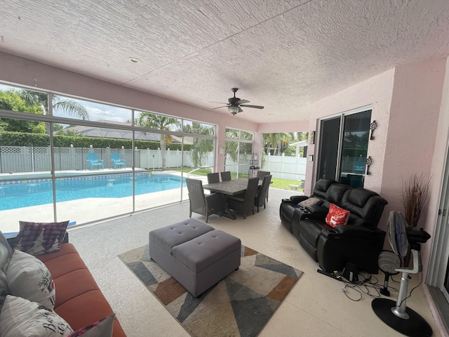 exterior space featuring a lanai, an outdoor living space, ceiling fan, and a patio