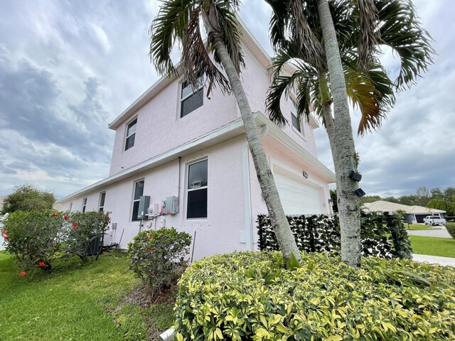 view of home's exterior with a yard and a garage