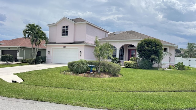 view of front of house featuring a front yard and a garage