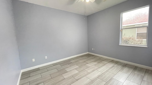 spare room with a wealth of natural light and ceiling fan