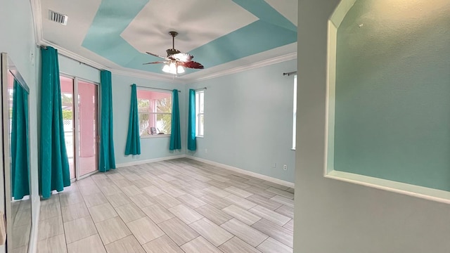 spare room featuring ceiling fan and crown molding