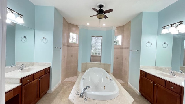 bathroom with tile patterned floors, tiled tub, ceiling fan, and vanity