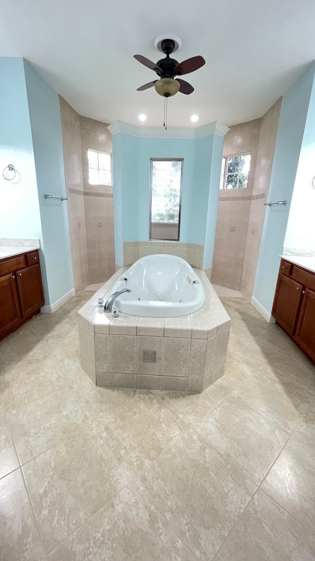 bathroom with vanity, ceiling fan, and plus walk in shower