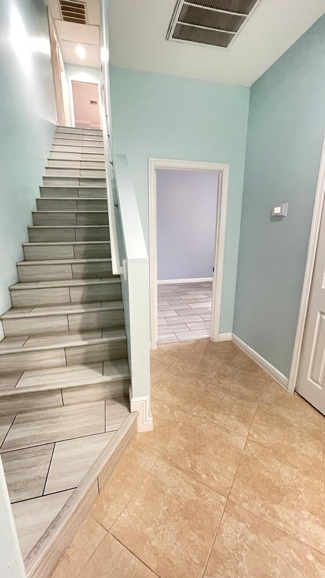 staircase with tile patterned floors