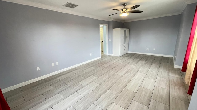 empty room with ceiling fan and crown molding