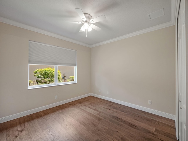 empty room with ornamental molding, ceiling fan, and hardwood / wood-style floors