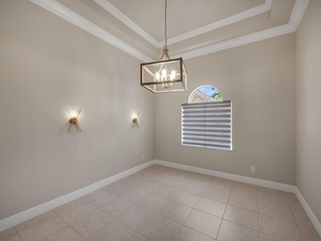 unfurnished room with tile patterned floors, a raised ceiling, crown molding, baseboards, and a chandelier