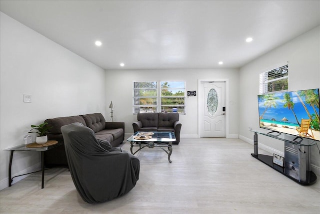 living room with plenty of natural light, baseboards, light wood-style floors, and recessed lighting