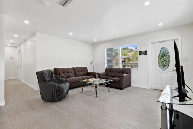 living area featuring recessed lighting, baseboards, light wood-style floors, and visible vents