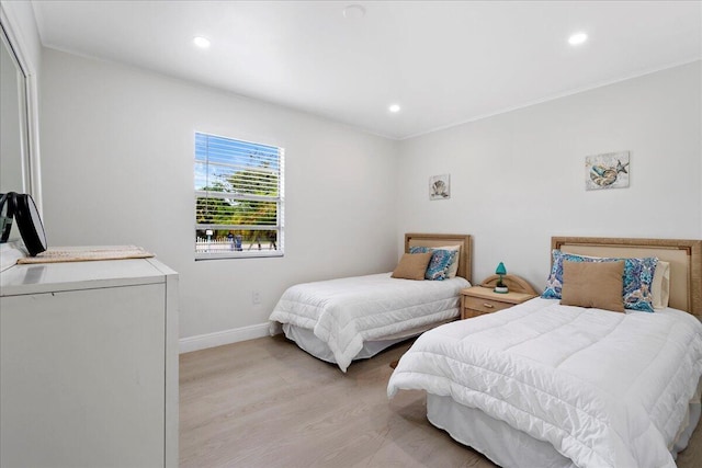 bedroom with baseboards, light wood-type flooring, crown molding, and recessed lighting