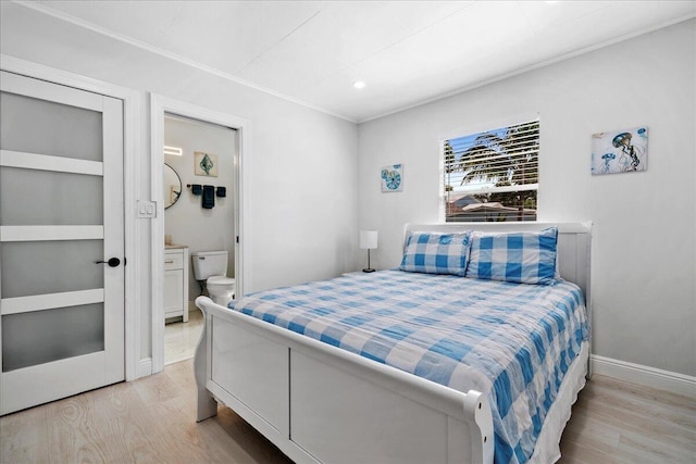 bedroom with crown molding, baseboards, and light wood-type flooring