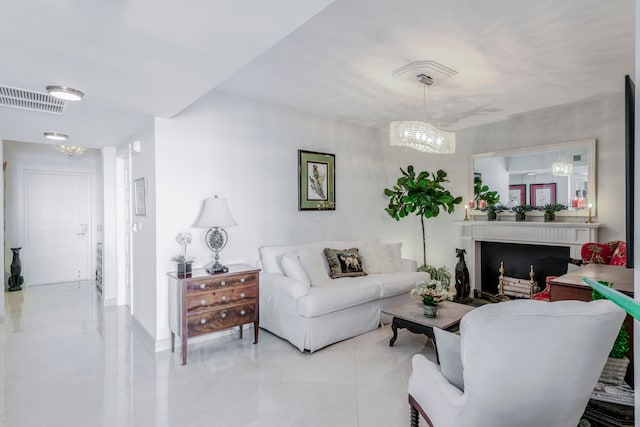 living room featuring an inviting chandelier and light tile patterned floors