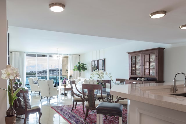 dining area with light tile patterned flooring, a notable chandelier, and expansive windows