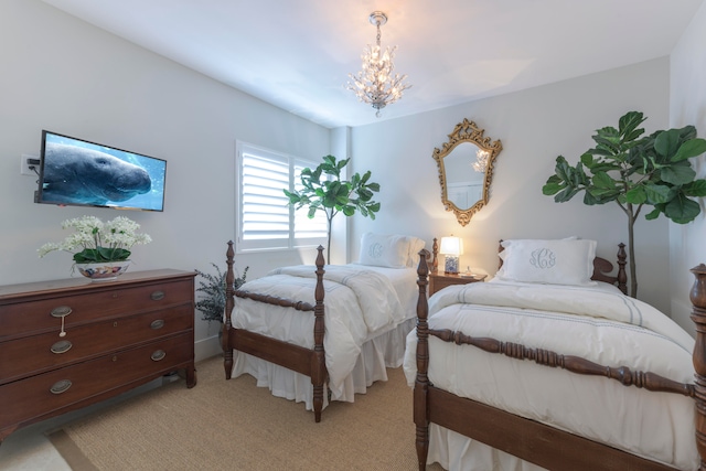 bedroom with an inviting chandelier and light carpet