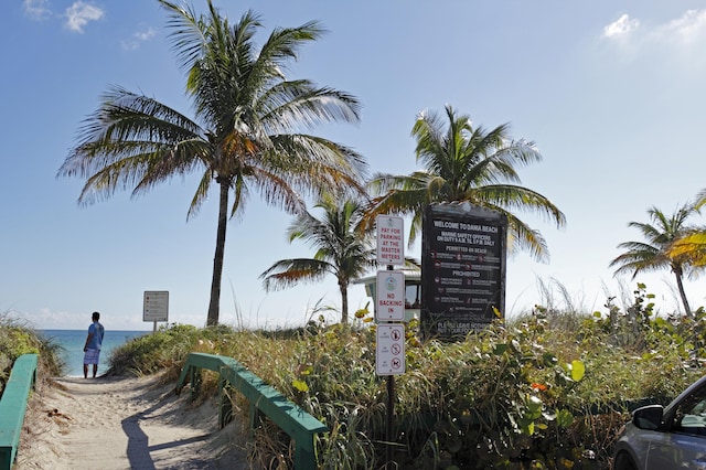 community sign featuring a water view