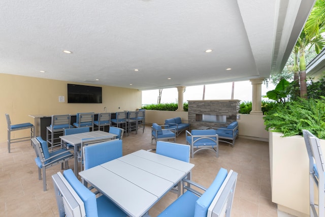 view of patio / terrace with an outdoor living space with a fireplace