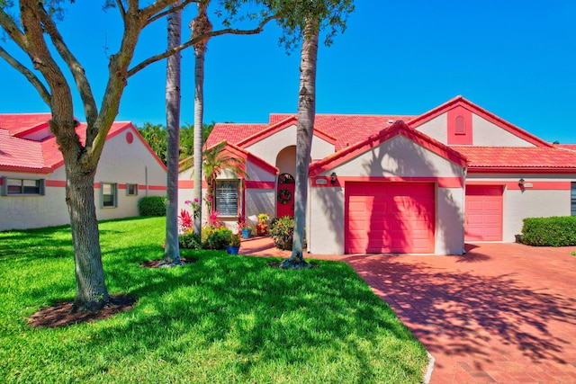 view of front of house with a garage and a front yard