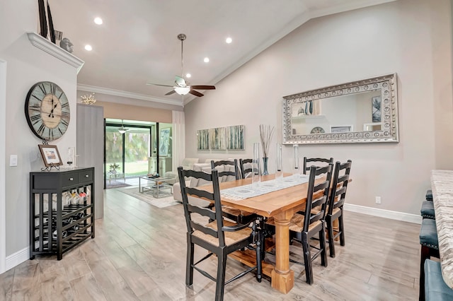 dining space featuring crown molding, lofted ceiling, ceiling fan, and light hardwood / wood-style flooring