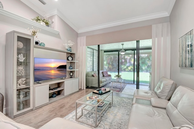 living room with vaulted ceiling, crown molding, and light hardwood / wood-style flooring