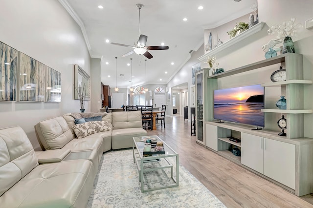 living room featuring high vaulted ceiling, ceiling fan, crown molding, and light wood-type flooring