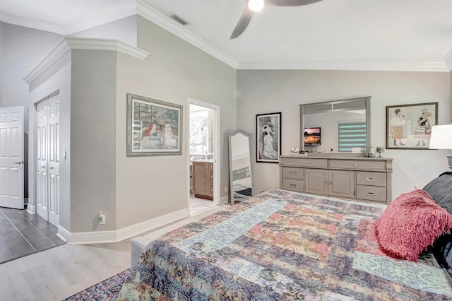 bedroom featuring a closet, ceiling fan, ornamental molding, wood-type flooring, and lofted ceiling