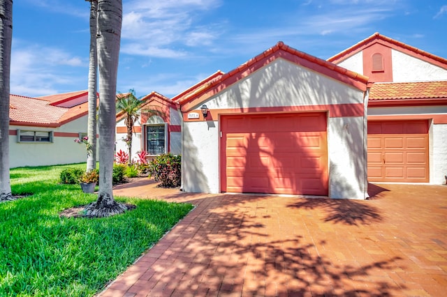 view of front of house with a front lawn and a garage