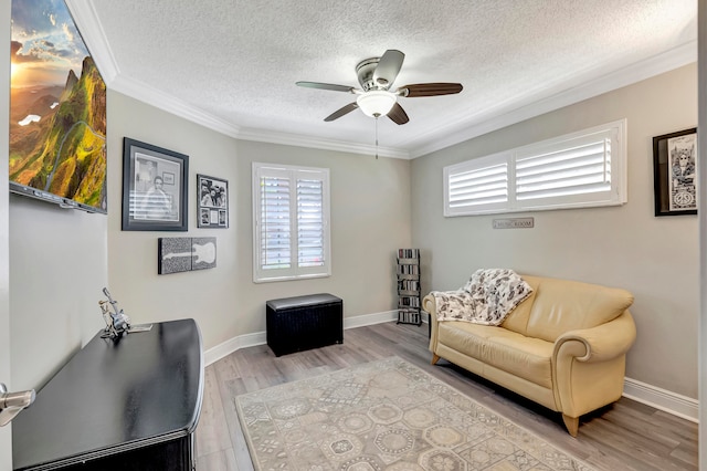 interior space featuring crown molding, ceiling fan, a textured ceiling, and wood-type flooring