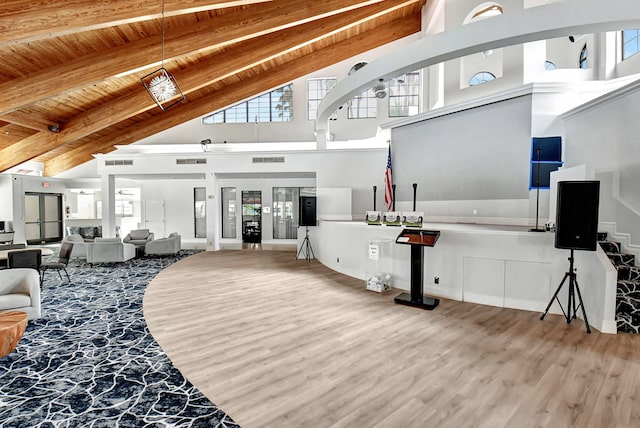 living room featuring high vaulted ceiling, wooden ceiling, wood-type flooring, and beam ceiling