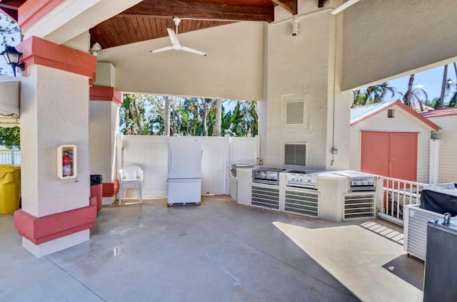 view of patio / terrace with a storage shed and ceiling fan