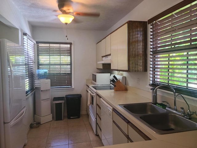 kitchen featuring ceiling fan, white appliances, light tile floors, sink, and white cabinets