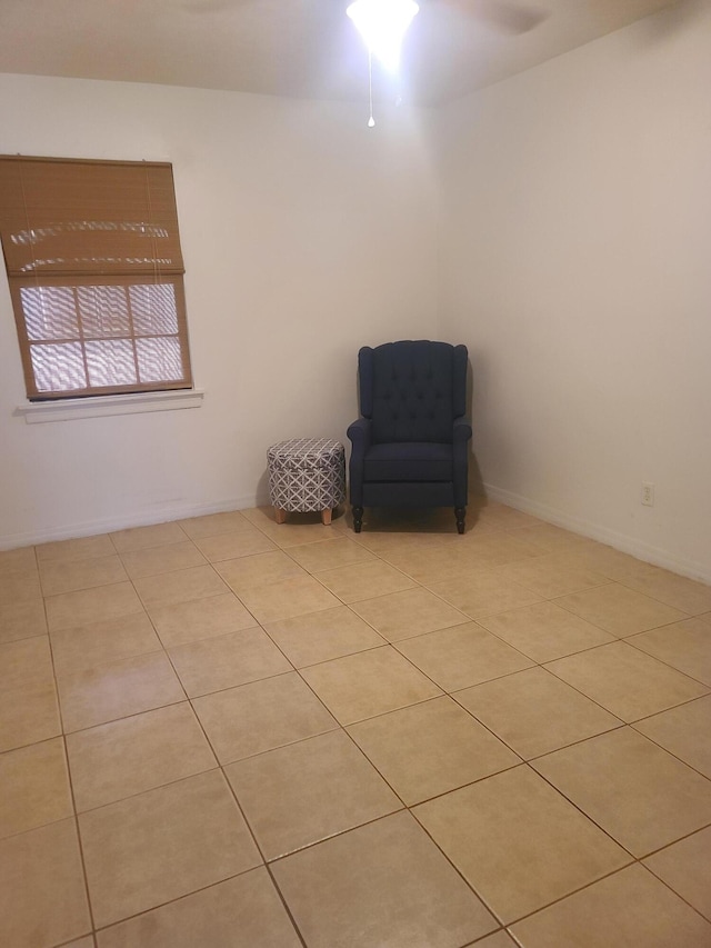 unfurnished room with ceiling fan and light tile floors