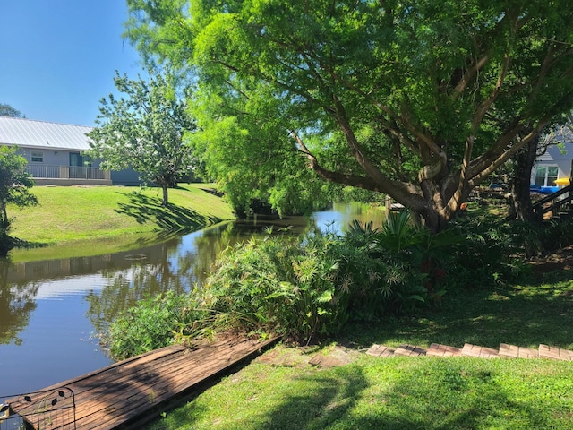 exterior space with a water view and a yard