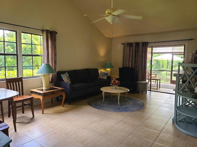 living room featuring a wealth of natural light, ceiling fan, light tile floors, and lofted ceiling