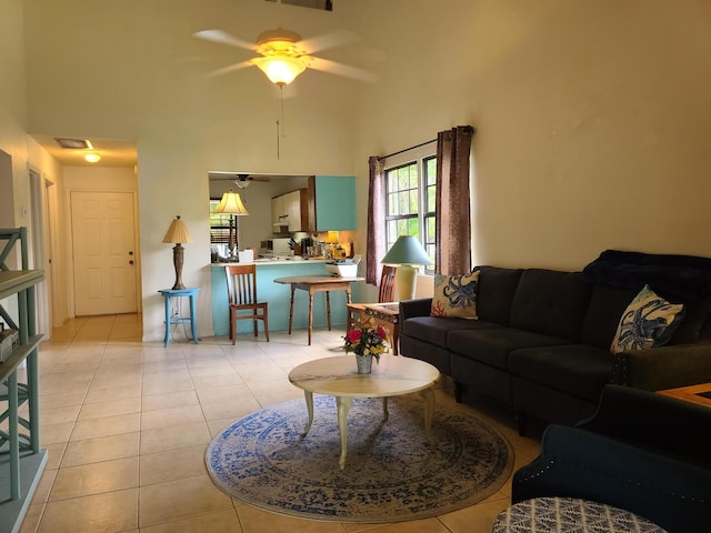 tiled living room featuring a high ceiling and ceiling fan