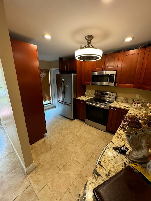 kitchen with light stone countertops and stainless steel appliances