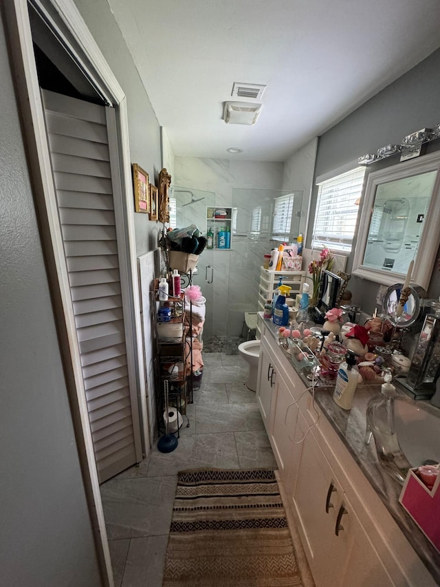 bathroom with walk in shower, vanity, and toilet