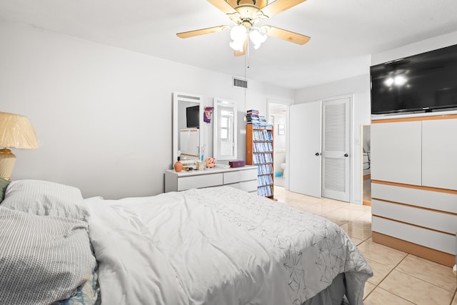 bedroom with ceiling fan, a closet, and light tile floors