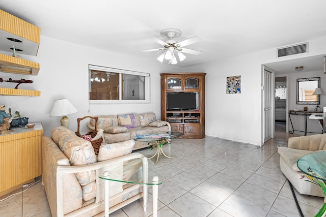 tiled living room with ceiling fan