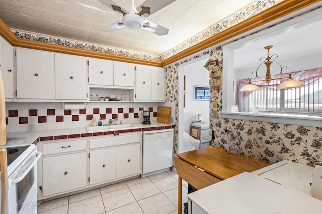 kitchen with white appliances, tile counters, white cabinets, and ceiling fan with notable chandelier