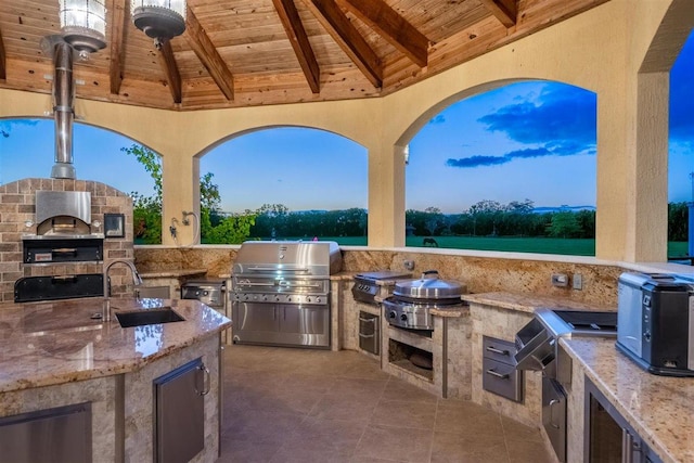 view of patio featuring a grill, an outdoor kitchen, and sink