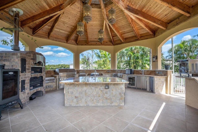 view of patio / terrace with a gazebo, an outdoor kitchen, and a grill